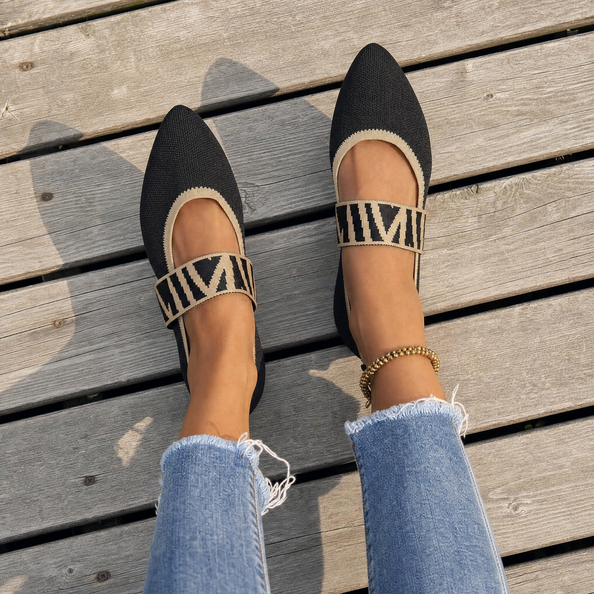 Woman wearing black knit pointed flats, lifestyle