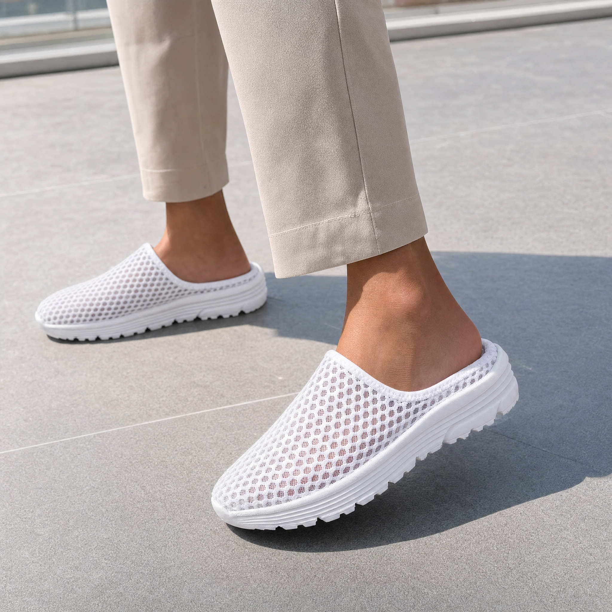 Woman wearing white mesh backless slip-on sneakers, lifestyle