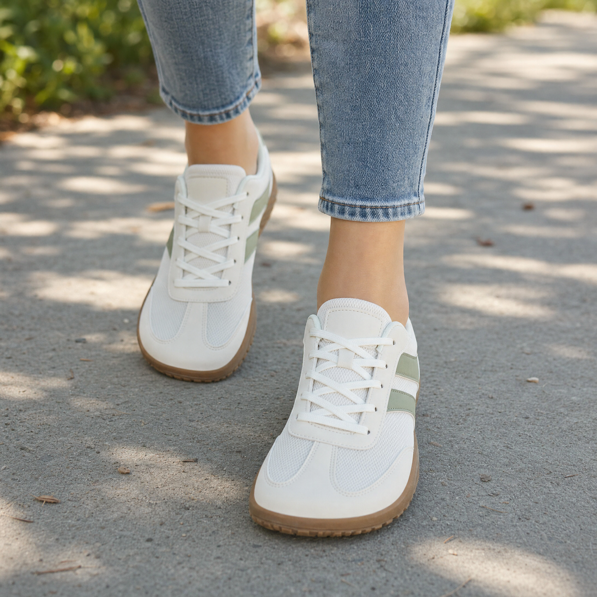 Woman wearing cream and sage green barefoot sneakers, lifestyle