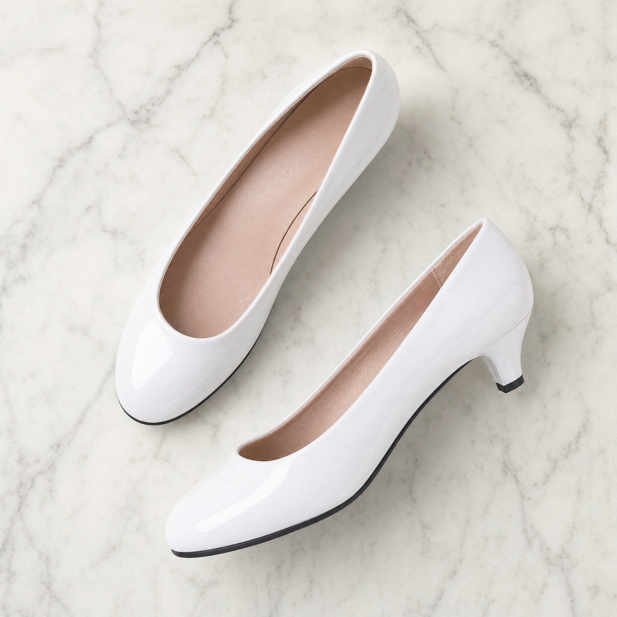 White patent round-toe kitten heel court pumps, flatlay