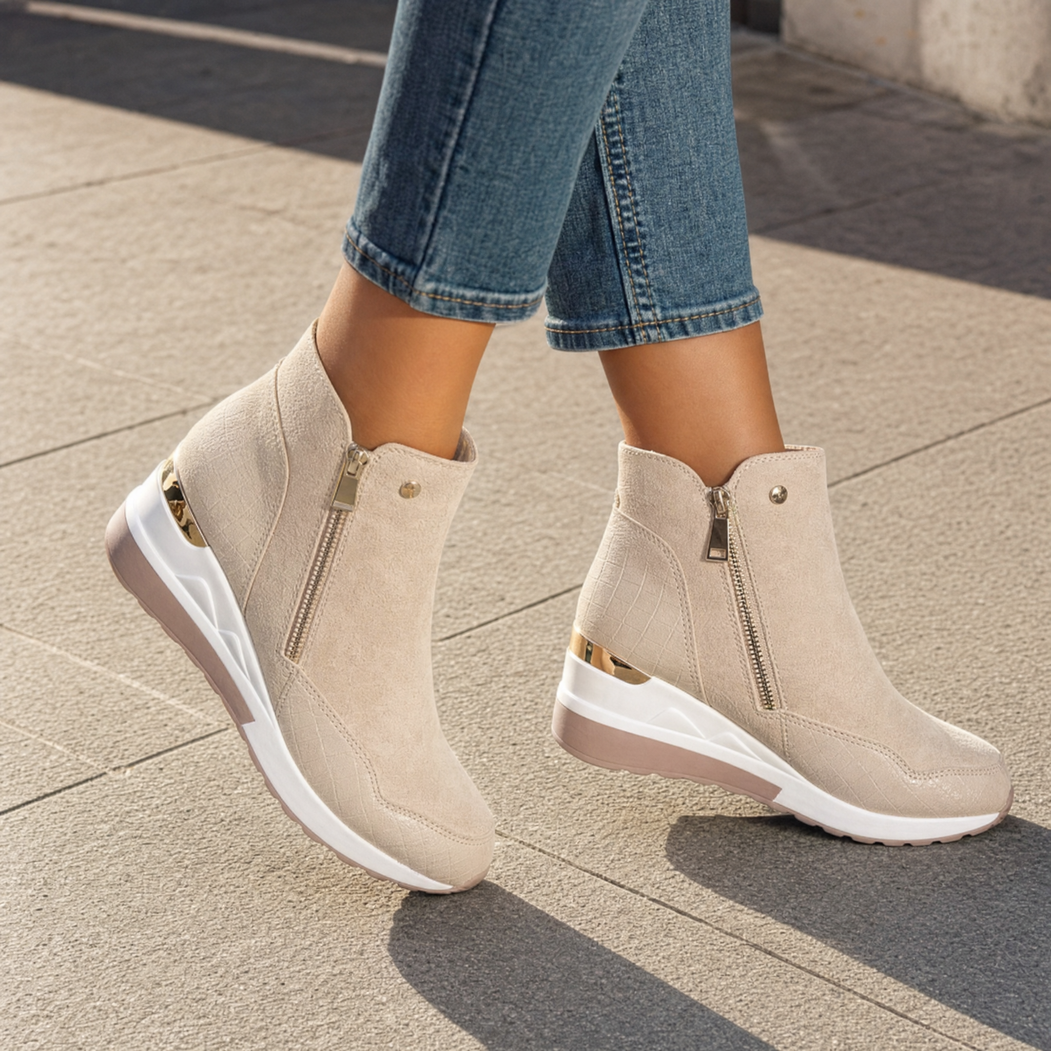 Woman wearing cream suede wedge ankle boots, lifestyle