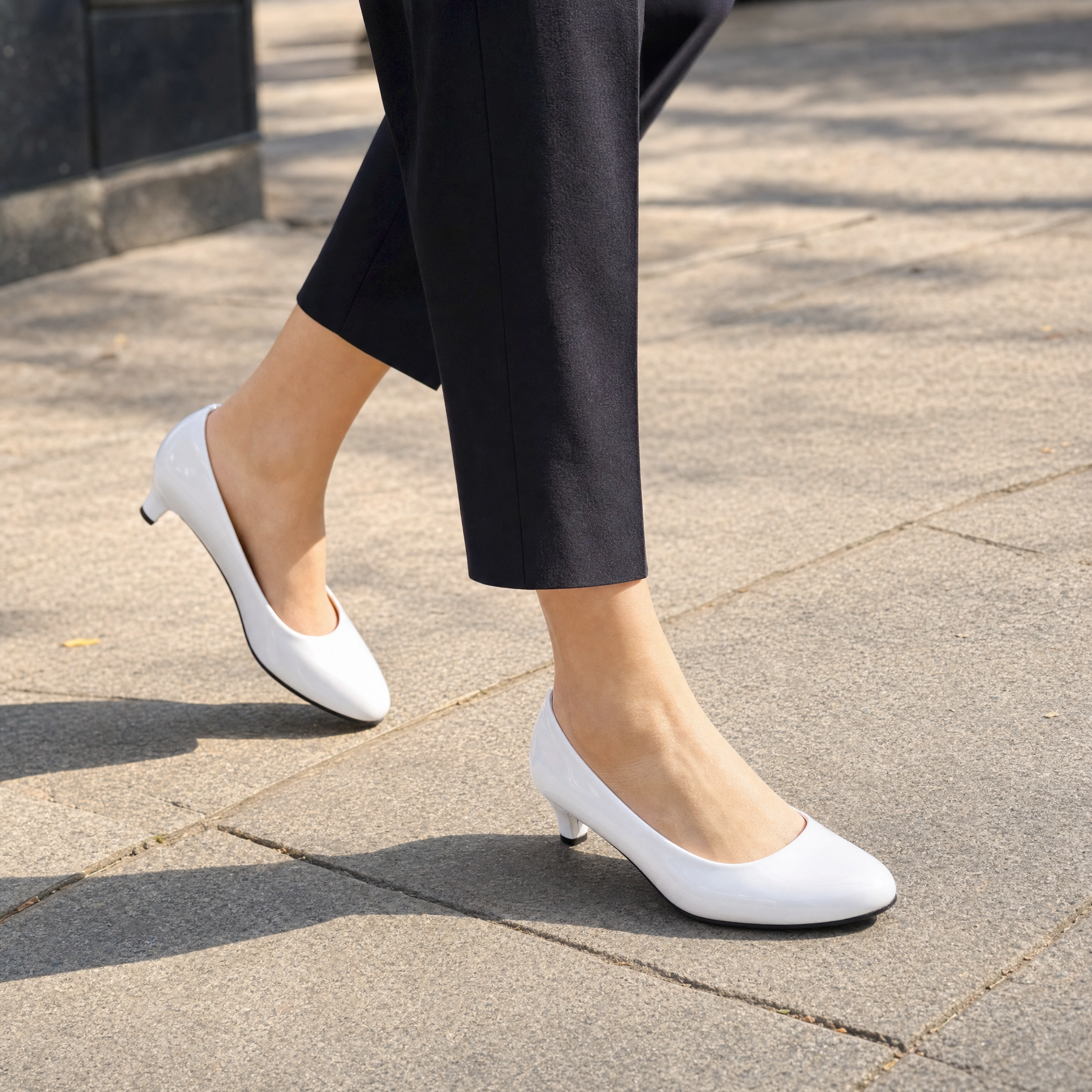 Woman wearing white patent kitten heel pumps, lifestyle