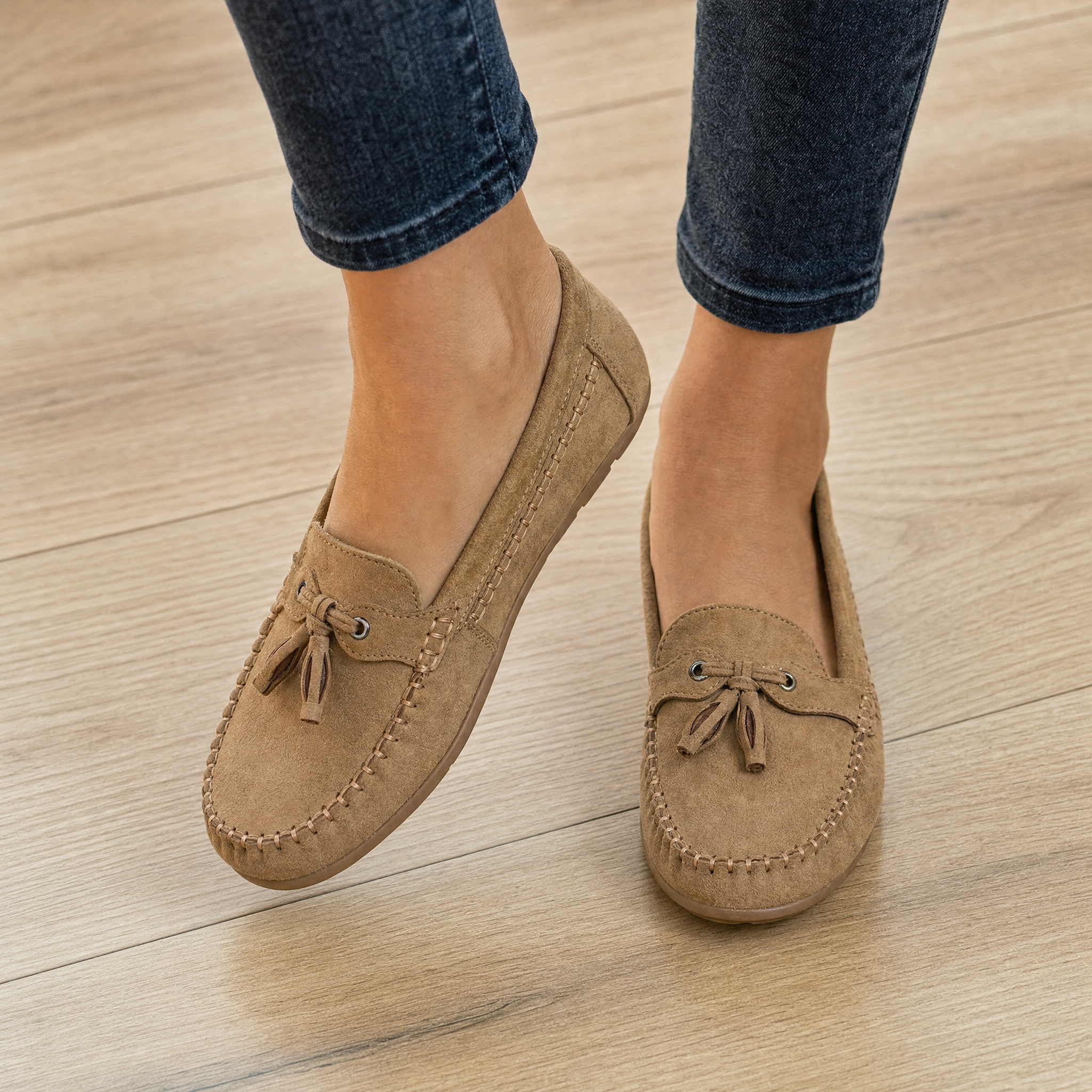 Woman wearing tan suede tassel loafers, lifestyle
