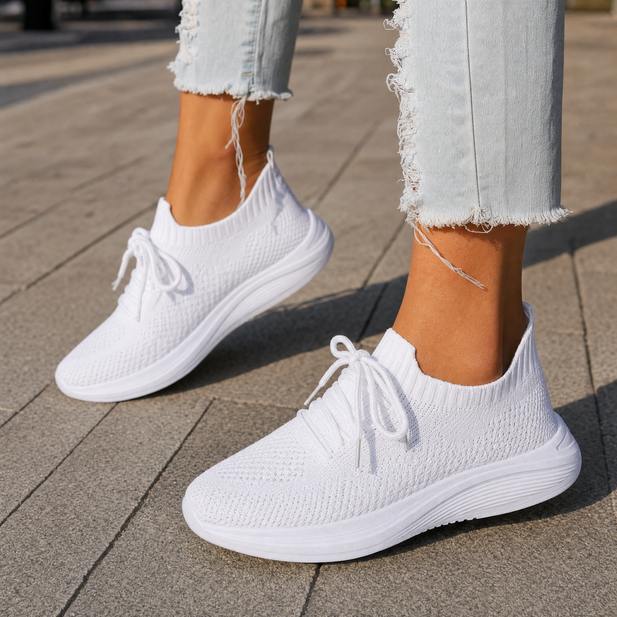 Woman wearing white knit slip-on sneakers, lifestyle